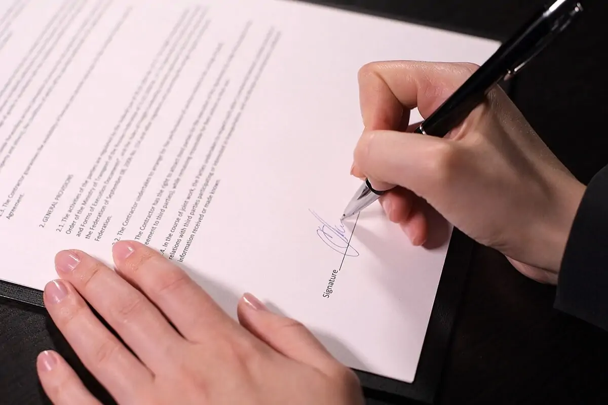 Person signing a legally binding contract.